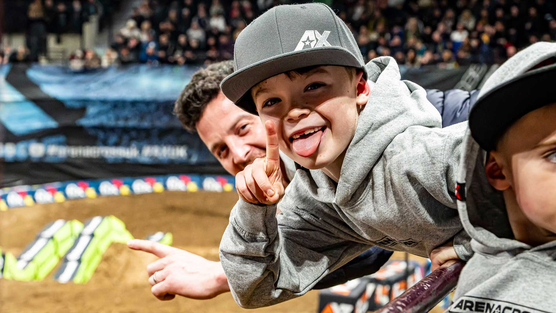 Young Arenacross fan reaching towards the camera at Wembley