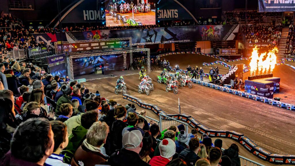 Arenacross British Championship riders racing in front of a packed indoor arena