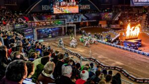 Arenacross British Championship riders racing in front of a packed indoor arena