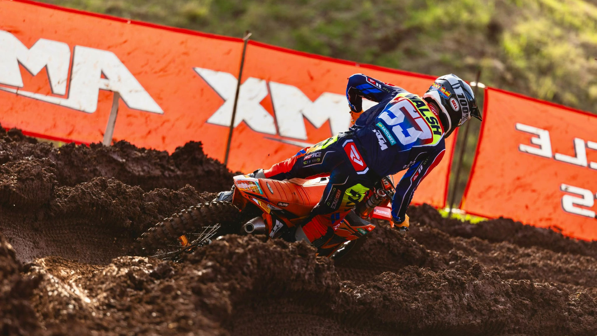 KTM motocross rider number 53 cornering on a dirt track